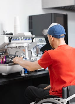 Man in a wheelchair making coffee at a cafe, demonstrating inclusivity