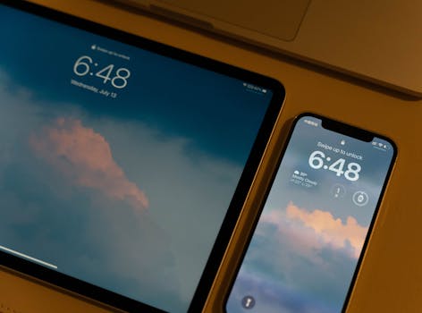 Close-up of modern digital devices with cloud-themed wallpaper and lock screens.